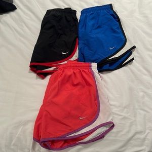 Women’s NIKE workout shorts ; size SMALL ; black, blue, pink